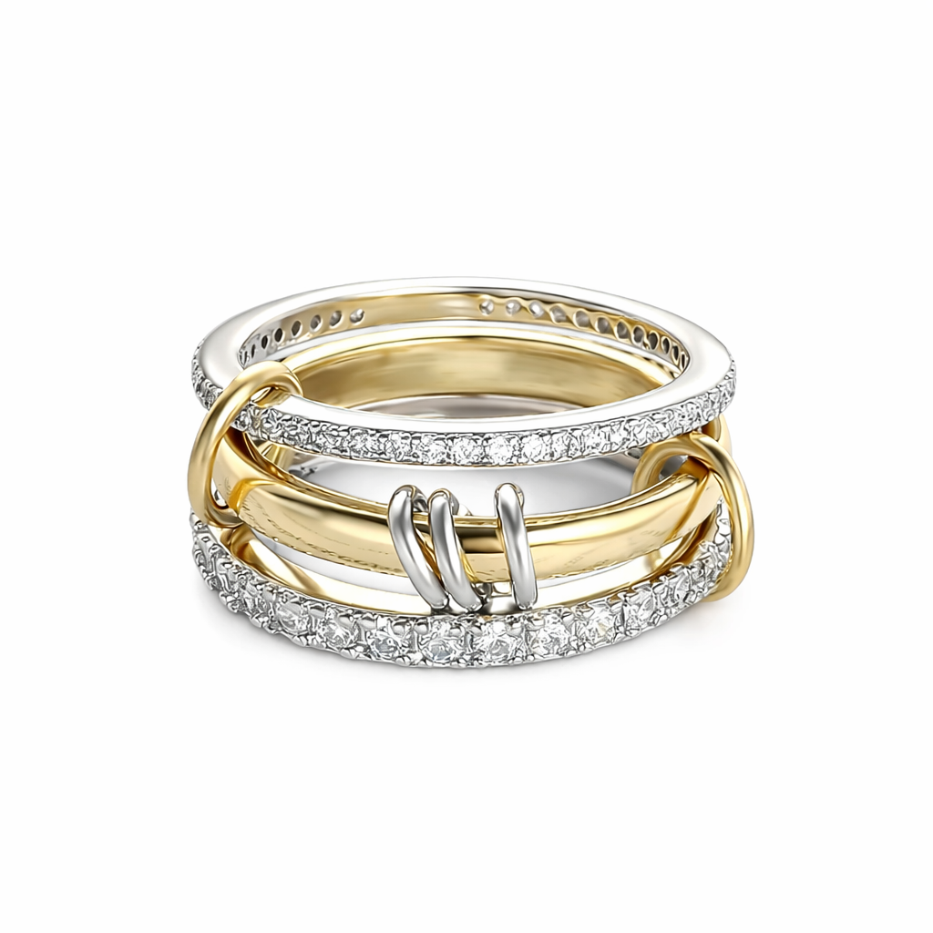 Three interlocking gold and silver rings with diamond accents on a white background