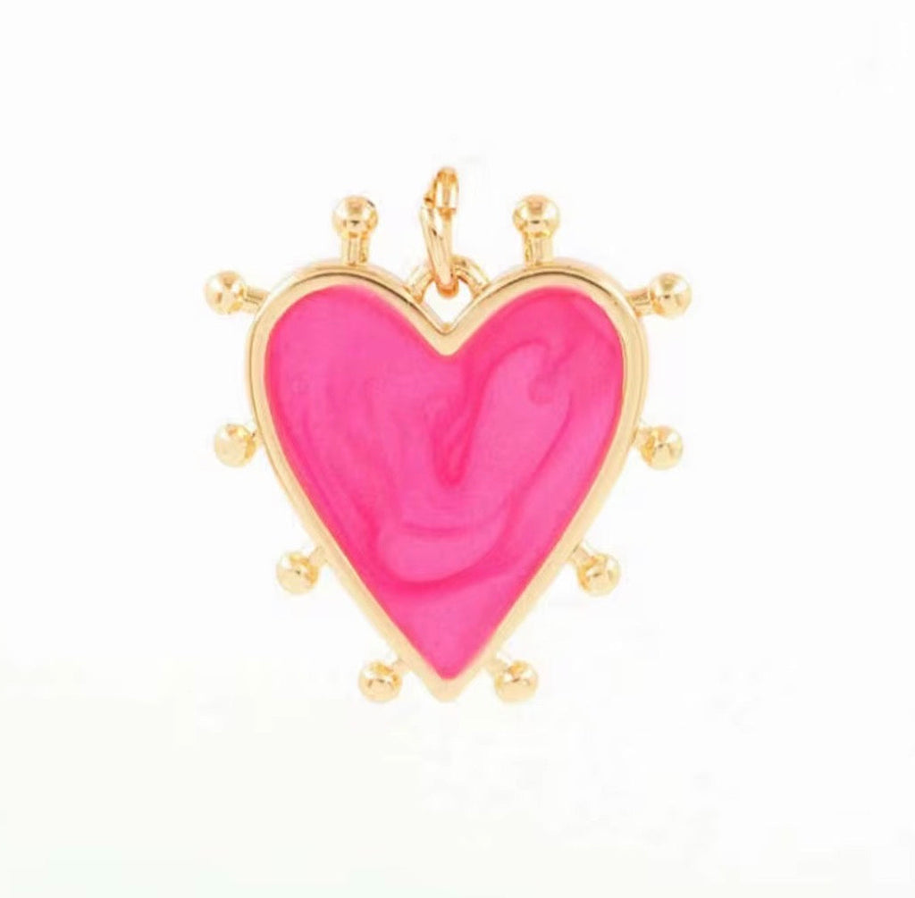 pink enamel heart charm with gold burst detailing, high shine gold plated pendant, playful jewellery piece