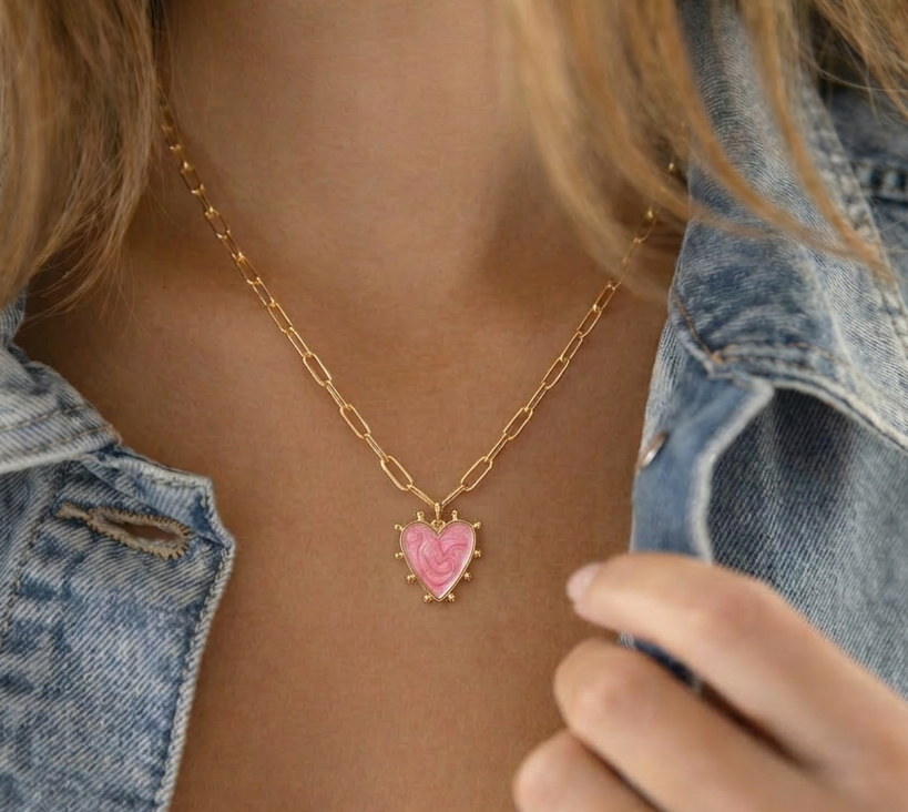 pink enamel heart charm necklace on model, gold heart pendant with burst detail, 18k gold plated jewellery