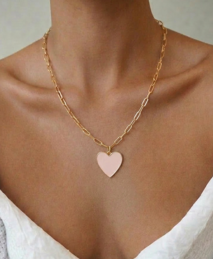 light pink heart charm necklace on model, gold pendant with enamel finish, 18k gold plated jewellery