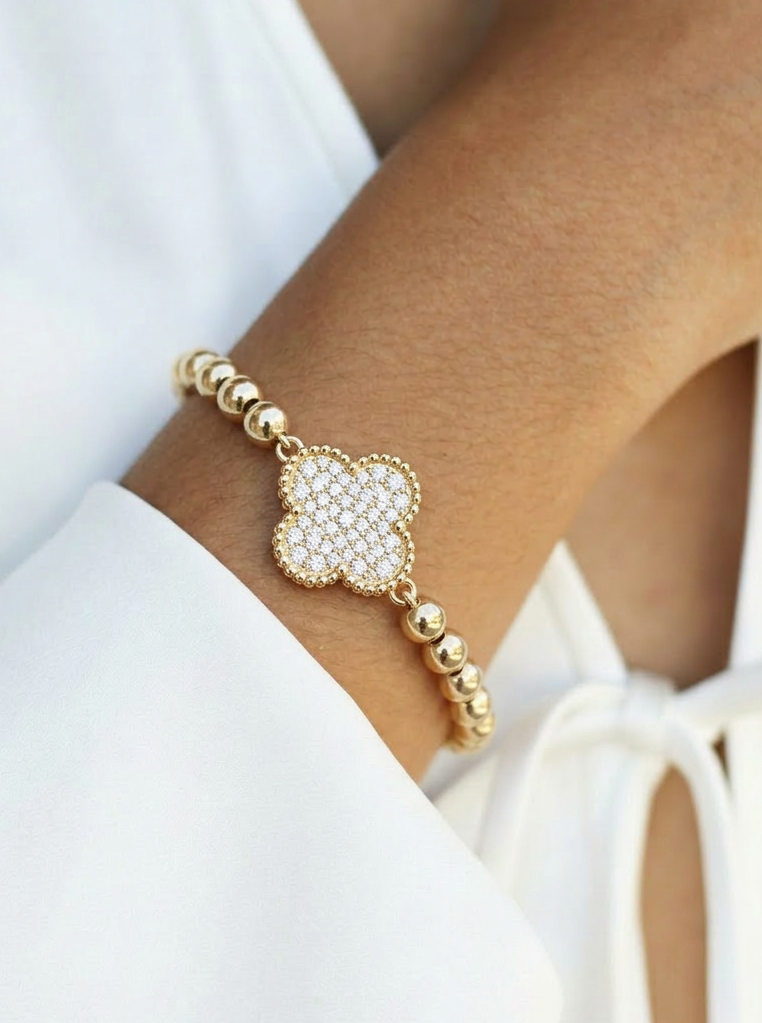 gold beaded clover bracelet on wrist, cubic zirconia clover charm, 14k gold plated stainless steel bracelet