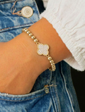 gold beaded clover bracelet on wrist, cubic zirconia clover charm, 14k gold plated stainless steel bracelet
