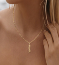 gold mama letter pendant necklace on model, dainty script charm necklace, 18k gold plated jewellery