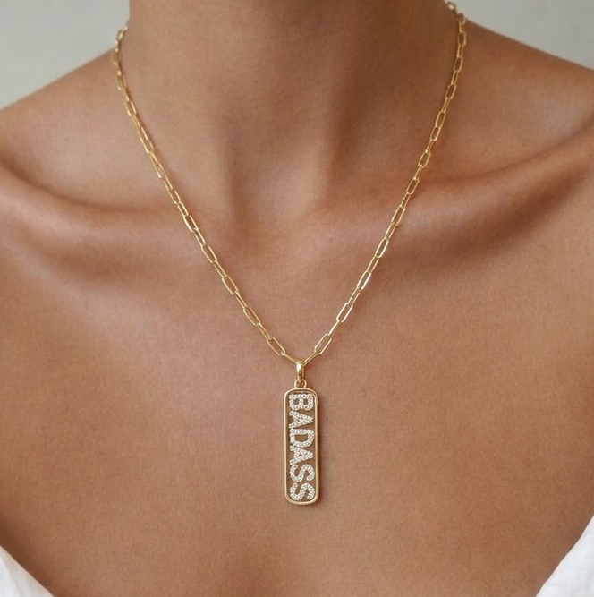 Gold pendant necklace with cubic zirconia letter detailing worn on model, dainty 18k gold tone jewellery