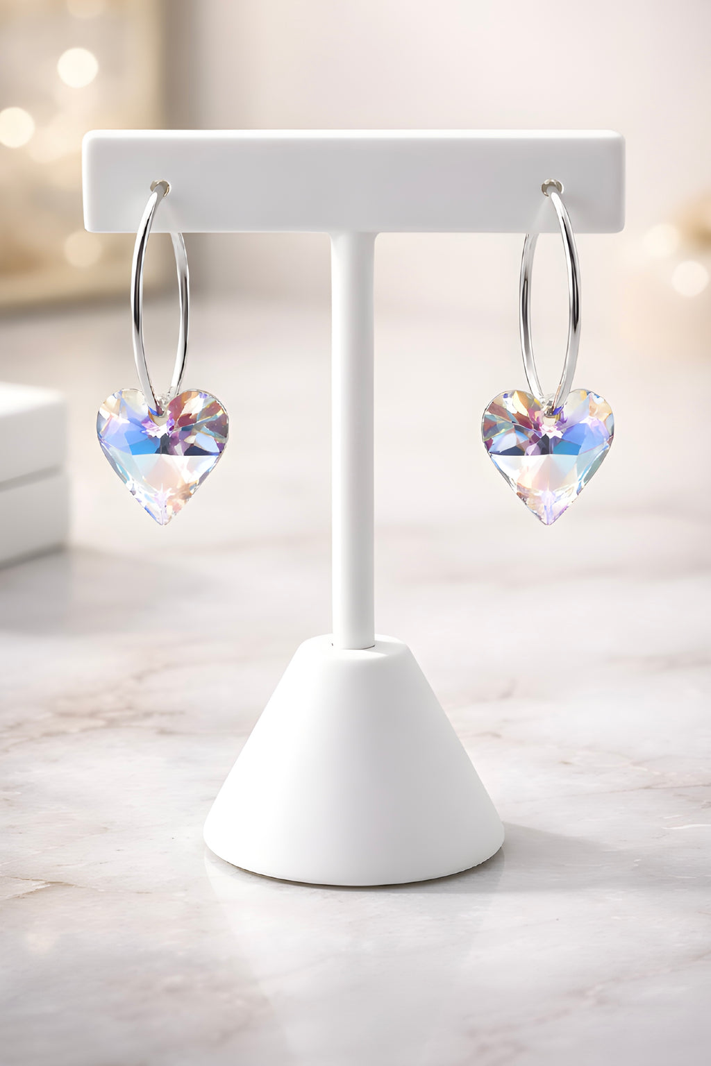 Silver hoop earrings with blue aurora crystal heart charm