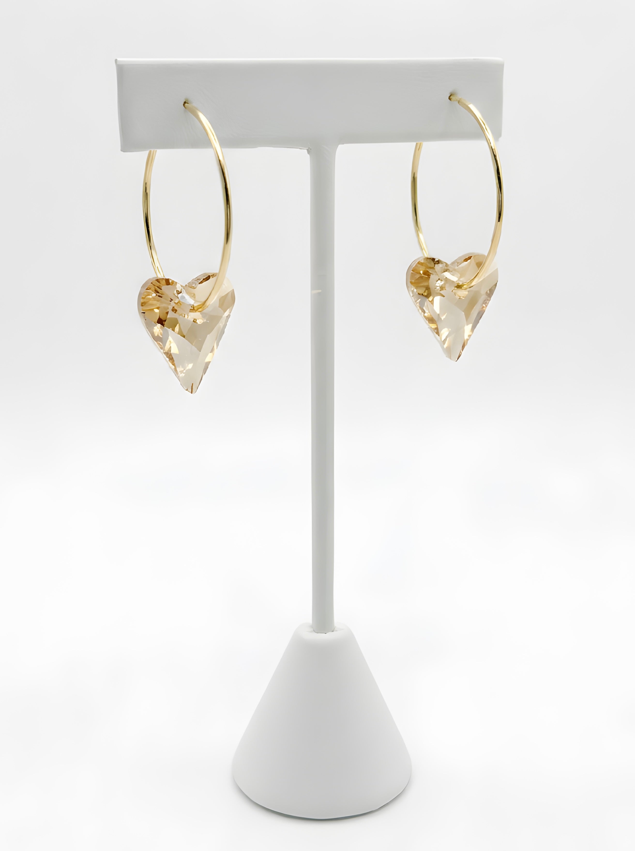  Gold hoop earrings with champagne crystal heart charm close-up