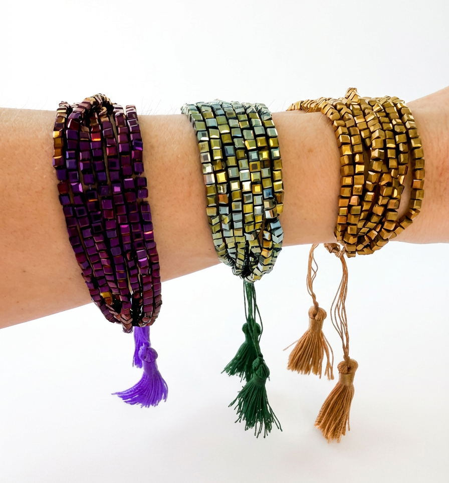 Three colorful beaded bracelets on a wrist against a white background