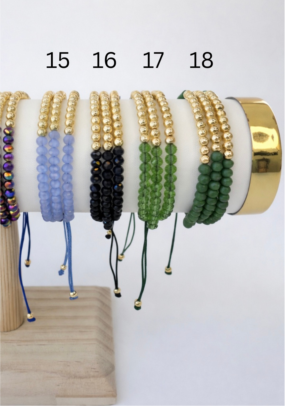 Set of beaded bracelets on a white and gold holder